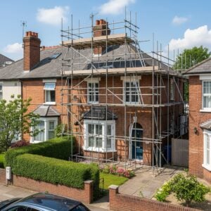 residential brick house in London with professionally installed scaffolding on the front facade, ready for renovation work.